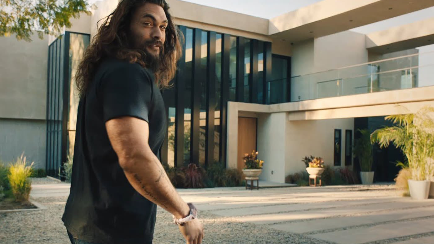 Rocket Mortgage ‘Comfortable’ — Jason Momoa outside a modern house
